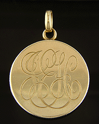 14kt gold locket with monogram.