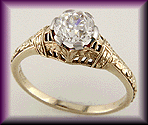 14 kt antique filigree ring with an Old European cut diamond.