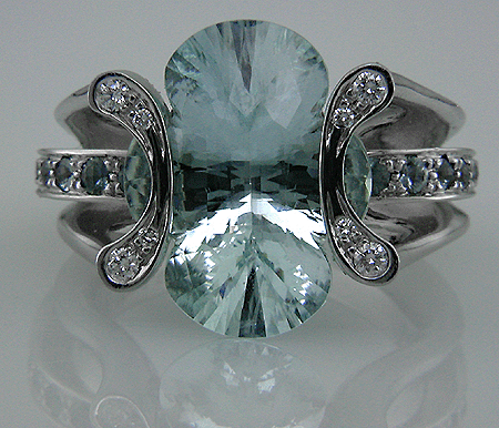 Platinum ring set with a clover-cut aquamarine, diamonds and 25 Montana sapphires.