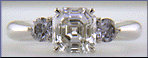 An Asscher-cut Diamond set with two Blue-Violet Round Diamonds in a hand-crafted platinum ring.