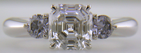 An Asscher-cut Diamond set with two Blue-Violet Round Diamonds in a hand-crafted platinum ring.