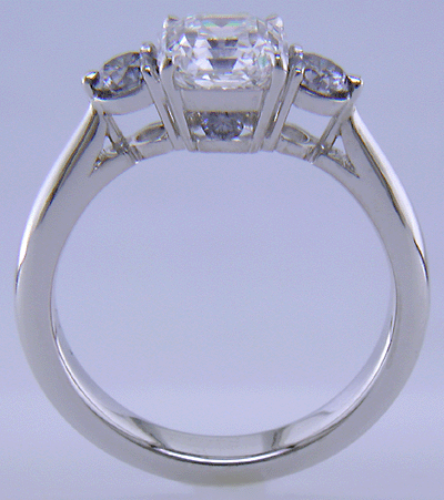 An Asscher-cut Diamond set with two Blue-Violet Round Diamonds in a hand-crafted platinum ring.