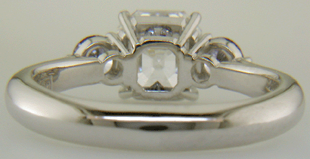 An Asscher-cut Diamond set with two Blue-Violet Round Diamonds in a hand-crafted platinum ring.