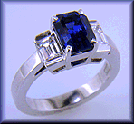 Emerald cut sapphire and diamond ring handcrafted in platinum.