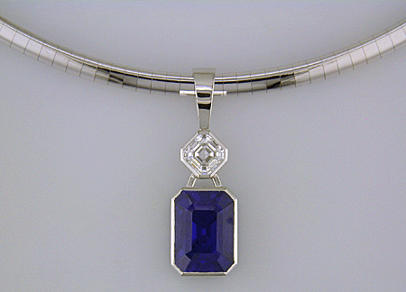 Custom platinum pendant featuring a beautiful Sapphire and an Asscher-cut Diamond.