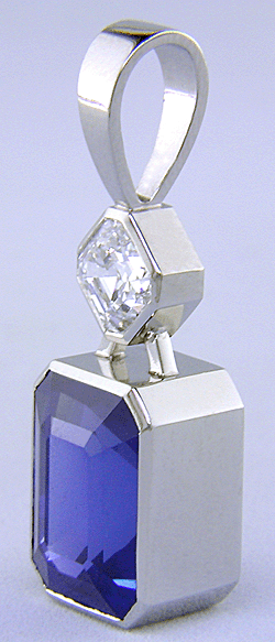 Custom platinum pendant featuring a beautiful Sapphire and an Asscher-cut Diamond.
