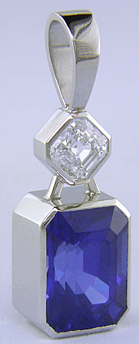 Custom platinum pendant featuring a beautiful Sapphire and an Asscher-cut Diamond.