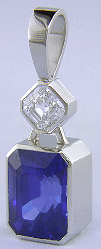Custom platinum pendant featuring a beautiful Sapphire and an Asscher-cut Diamond.