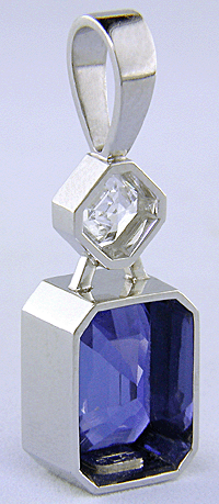Custom platinum pendant featuring a beautiful Sapphire and an Asscher-cut Diamond.