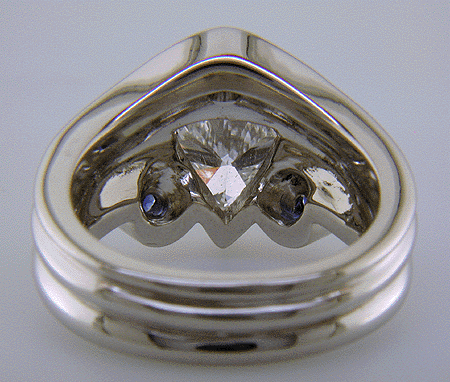 Inside view of trilliant diamond ring with three small sapphires.