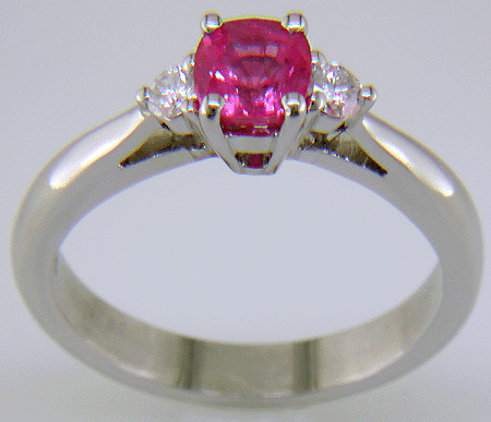 Cushion-cut Pink Sapphire set with two round diamonds in a hand-crafted platinum ring. (J8597)
