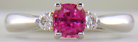 Cushion-cut Pink Sapphire set with two round diamonds in a hand-crafted platinum ring. (J8597)