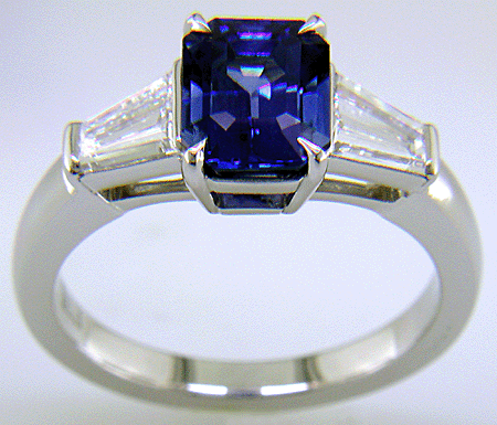 Emerald-cut Sapphire with tapered baguette diamonds in a custom platinum ring. (J8643)