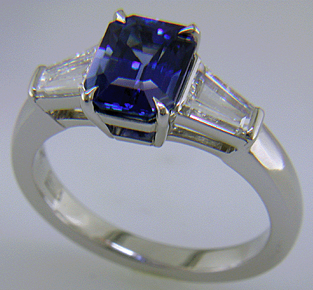 Emerald-cut Sapphire with tapered baguette diamonds in a custom platinum ring. (J8643)