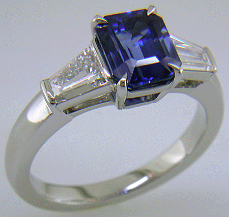 Emerald-cut Sapphire with tapered baguette diamonds in a custom platinum ring. (J8643)