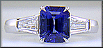 Emerald-cut Sapphire with tapered baguette diamonds in a custom platinum ring. (J8643)