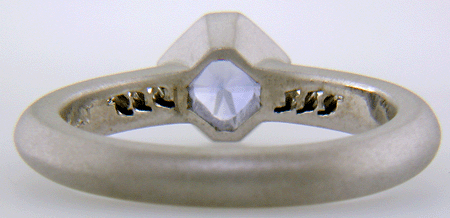 Inside view of Flanders-cut Sapphire with round diamonds in a custom platinum ring.