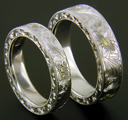 Hand engraved platinum bands set with yellow diamonds
