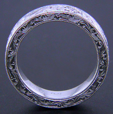Side view of hand-engraved platinum band set with diamonds.
