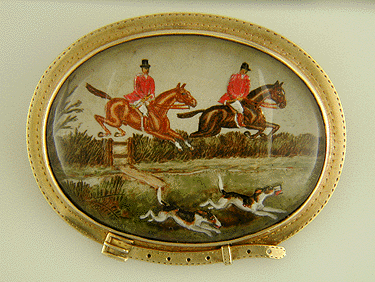 Edwardian brooch with reverse intaglio of hunting chase scene set in cinch strap motif bezel.