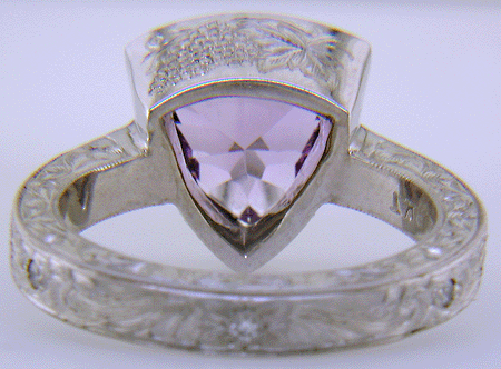 Concave-faceted Amethyst set in an engraved platinum ring. (J7415)