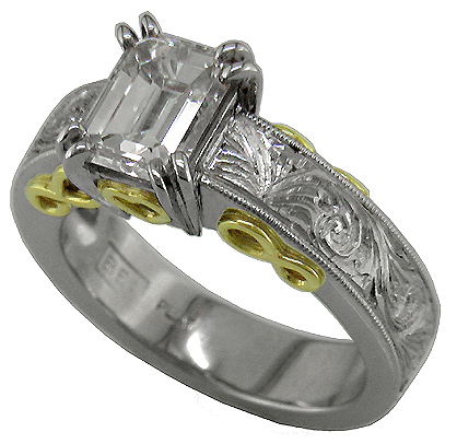 Hand-engraved platinum and gold engagement ring with an emerald cut diamond.