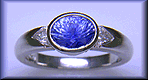 Concave-faceted sapphire and trilliant diamonds in a custom platinum ring.