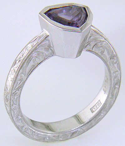 Hand engraved platinum ring with a shield-shape Lavender Spinel. (J8710)
