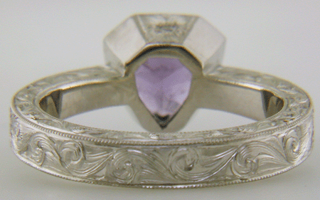 Hand engraved platinum ring with a shield-shape Lavender Spinel. (J8710)