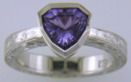 Hand engraved platinum ring with a shield-shape Lavender Spinel. (J8710)
