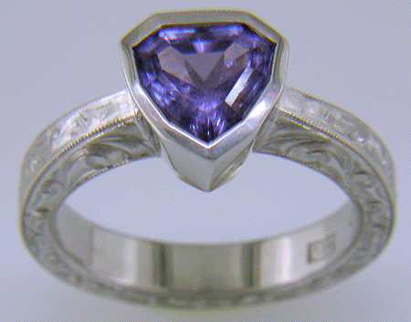 Hand engraved platinum ring with a shield-shape Lavender Spinel. (J8710)