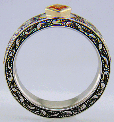 A beautifully hand-engraved ring set with fiery orange Manderin Garnets. (J8703)
