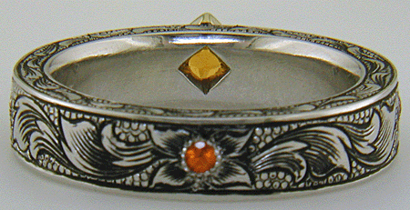 A beautifully hand-engraved ring set with fiery orange Manderin Garnets. (J8703)