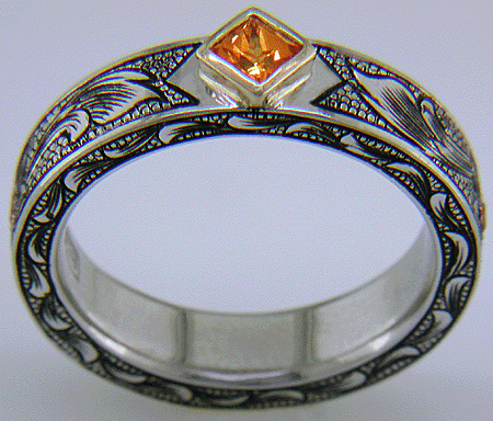 A beautifully hand-engraved ring set with fiery orange Manderin Garnets. (J8703)