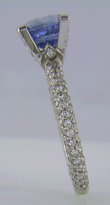 Sapphire set with pave diamonds in a platinum ring.