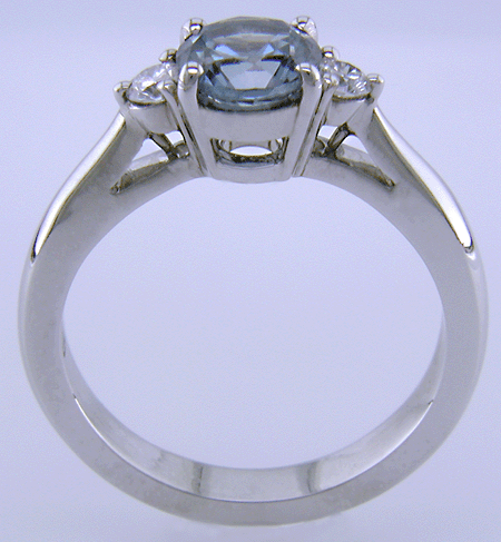 Side view of Montana Sapphire set with two round diamonds in a hand-crafted platinum ring.