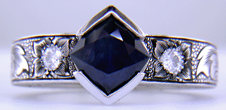 A Montana Sapphire set with diamonds in a beautifully hand-engraved platinum ring.