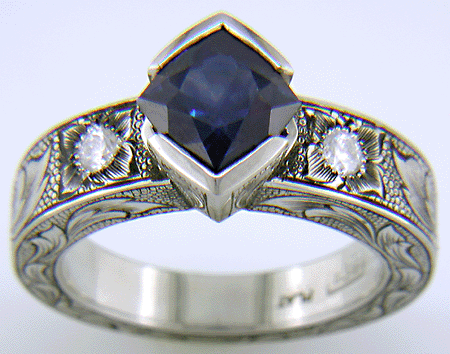 A Montana Sapphire set with diamonds in a beautifully hand-engraved platinum ring.