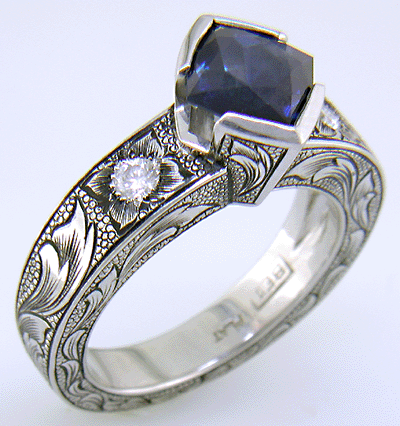 A Montana Sapphire set with diamonds in a beautifully hand-engraved platinum ring.