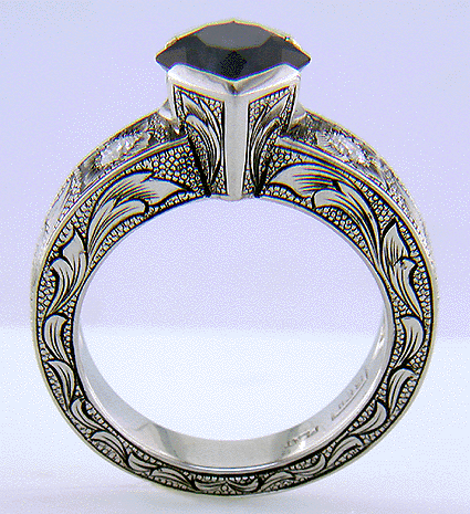 Side view of hand-engraved ring set with a Montana Sapphire and diamonds.