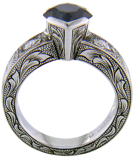 Side view of hand-engraved ring set with a Montana Sapphire and diamonds.