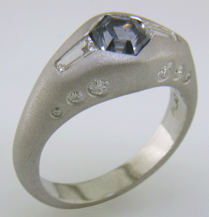 Hand-crafted Montana Sapphire and baguette diamond ring crafted in platinum. (J8433)