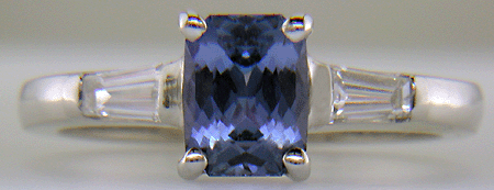 Morph-cut Sapphire with tapered baguette diamonds in a custom platinum ring.