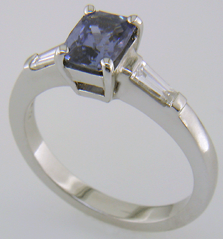 Morph-cut Sapphire with tapered baguette diamonds in a custom platinum ring.