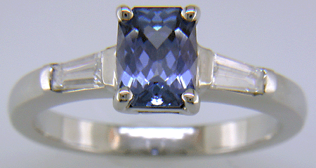 Morph-cut Sapphire with tapered baguette diamonds in a custom platinum ring.