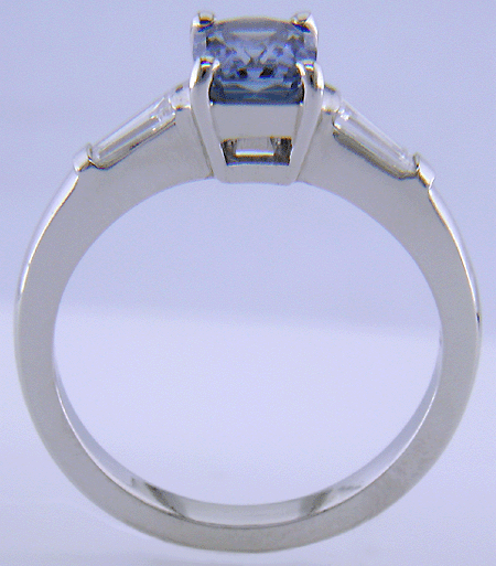 Morph-cut Sapphire with tapered baguette diamonds in a custom platinum ring.