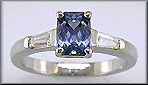 Morph-cut Sapphire with tapered baguette diamonds in a custom platinum ring.