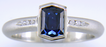 Morph-cut Sapphire with round diamonds in a custom platinum ring. (J8543)