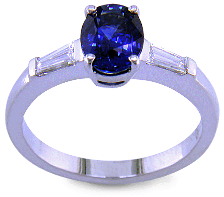 Side view of oval Sapphire set with tapered baguette diamonds in a handcrafted platinum ring. (J8410)