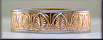 Hand-engraved platinum and rose gold band with Red Spinels. (J7245)